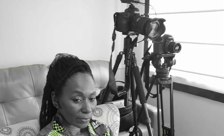 Black female reporter looking pensive while waiting for an interview