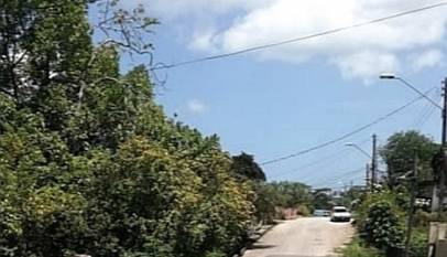 Black woman walking in the middle of the road at distance