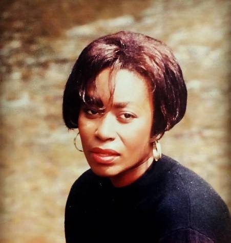 Young black woman in black top and relaxed hair