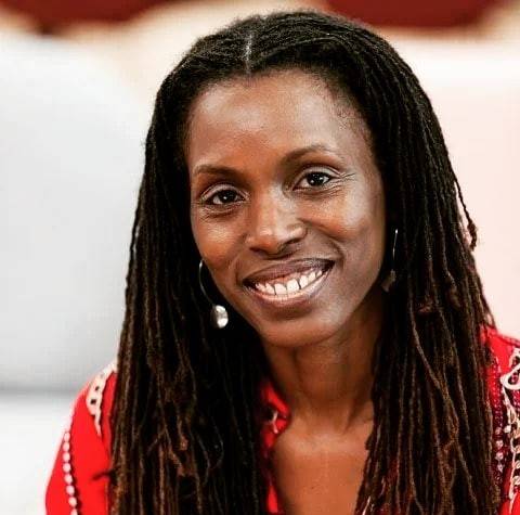 Black woman with long black hair smiling in red top