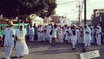 Procession of African celebrants in white at the Obatala festival Trinidad